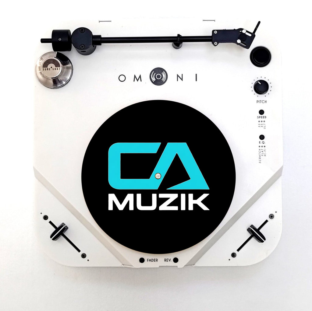 Black CA Muzik slipmat with blue CA logo and white MUZIK lettering, shown on a white turntable